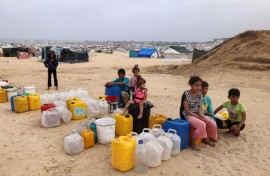 Displaced Palestinian children wait for water at their tent camp in Rafah -- the UN children's agency estimates the war has displaced around 850,000 children in Gaza