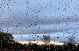 File: Raindrops seen on a window. eNCA/Estelle Bronkhorst
