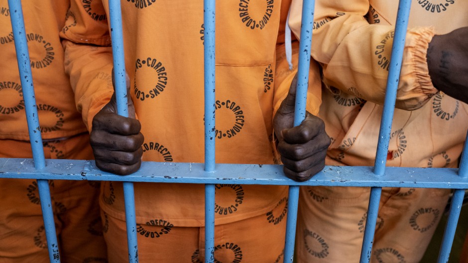 File: Inmates stand behind bars in The Maximum Security Section, of The Leeuwkop Correctional Facility, Bryanston.