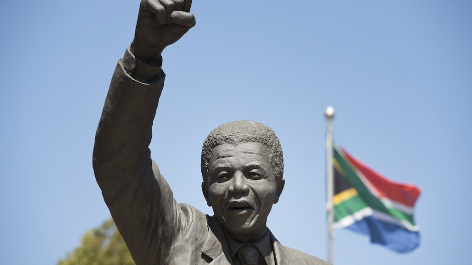 A statue of Nelson Mandela, an anti-apartheid revolutionary and the former president of South Africa, depicting him walking to freedom with a South African national flag in the background, stands in front of the entrance of the Drakenstein Prison, previously called Victor Verster Prison, in Paarl on January 23, 2020