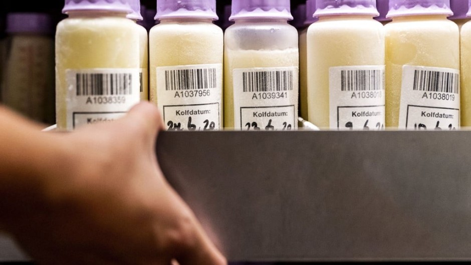 FILE: A member of staff of breast milk bank of the VUmc carries a boxe with bottles containing breast milk in Amsterdam, on August 19, 2020