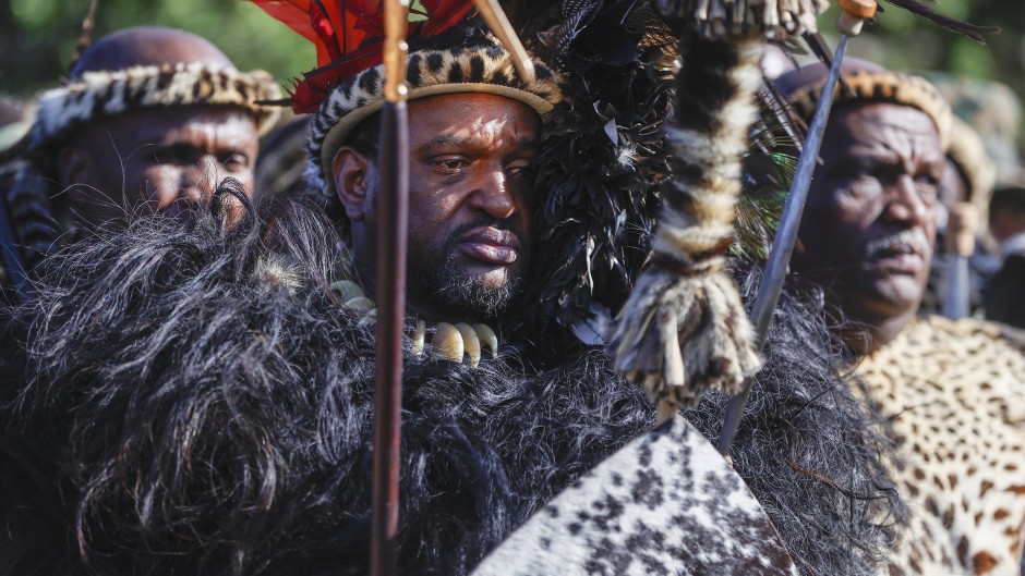 File: King of Amazulu nation Misuzulu kaZwelithini (C) gestures as he stands with Amabutho (Zulu regiments) during his coronation at the KwaKhangelamankengane Royal Palace in Kwa-Nongoma 300km north of Durban on August 20, 2022. Phill Magakoe / AFP