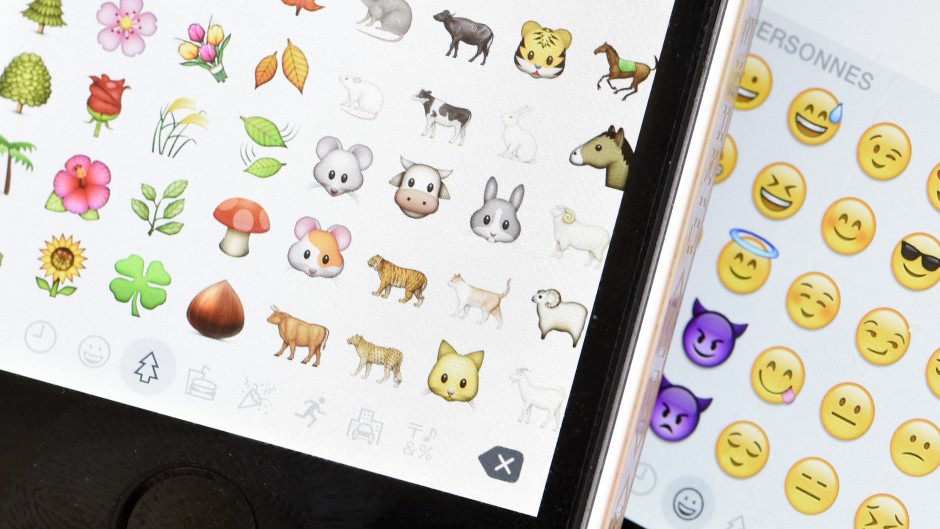 File: A picture shows emoji characters also known as emoticons on the screens of two mobile phones. MIGUEL MEDINA / AFP