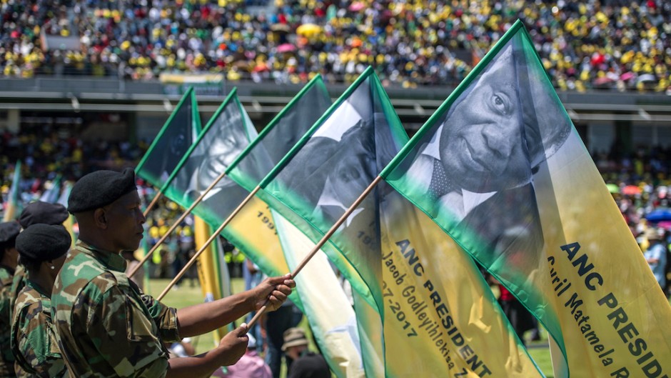 Soldiers hold banners bearing portraits of the former and current ANC presidents during the African National Congress's 106th-anniversary celebrations held at Absa Stadium in East London on January 13, 2018.