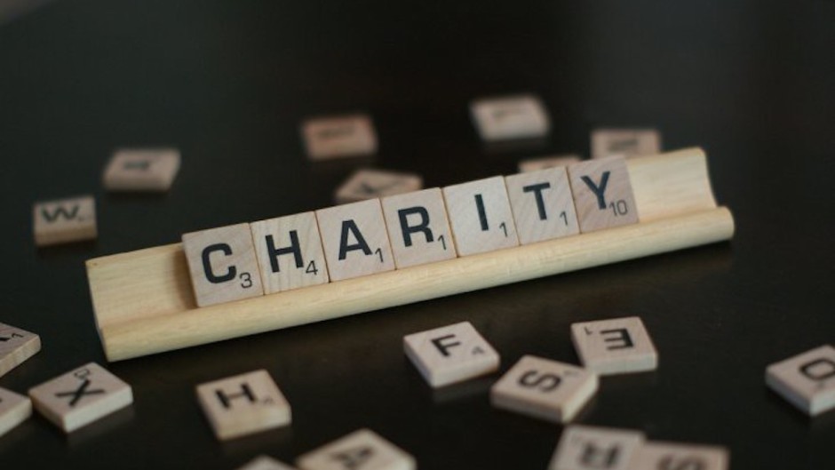 File image of the word 'charity' spelled in Scrabble tiles.