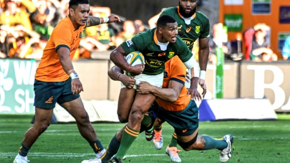 South Africa's Damian Willemse tries to ride an Australian tackle