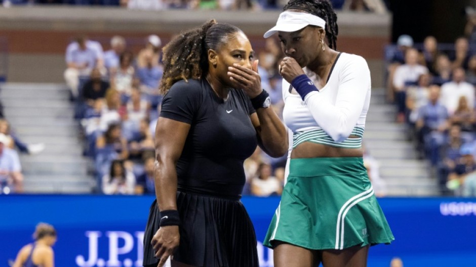 Serena Williams (left) and Venus Williams were beaten in the opening round of the women's doubles at the US Open on Thursday