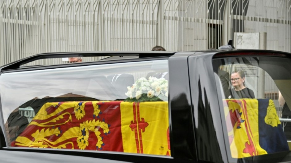 People place flowers for Queen Elizabeth II in Windsor