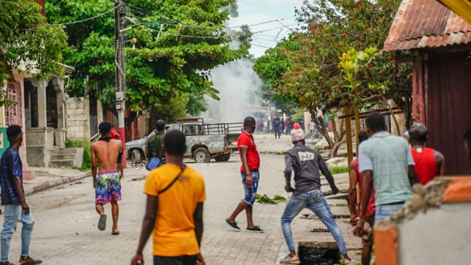 Haitians throw stones at the police during a violent demonstration in August 2022; they were protesting the rising cost of living and insecurity as the country, the poorest in the Western hemisphere, is mired in gang violence and political turmoil