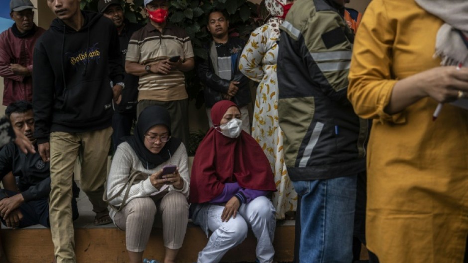 As night fell, the hustle and bustle at the hospital died down. Relatives laid on mats and covered up with blankets to get some rest outside the facility