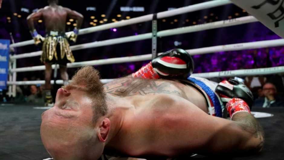 Former world heavyweight champion Deontay Wilder, left, poses moments after knocking out Finland's Robert Helenius, front, in the first round of their fight in New York