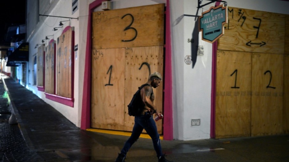 Businesses in the tourist area of Puerto Vallarta in Jalisco state, Mexico, boarded up shopfronts in preparation for Hurricane Roslyn's landfall