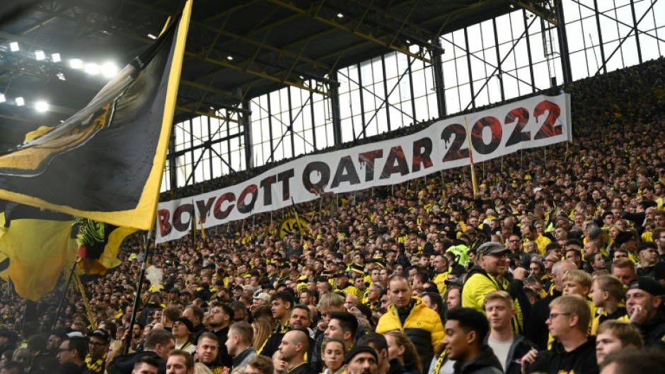 Dortmund fans in the club's famous 'yellow wall' hold up a banner reading "#Boycott Qatar 2022" 