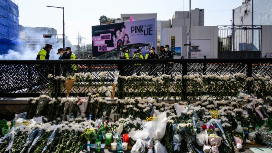 Flower tributes are seen at a makeshift memorial outside a subway station in Seoul's Itaewon district, two days after a deadly Halloween surge in the area