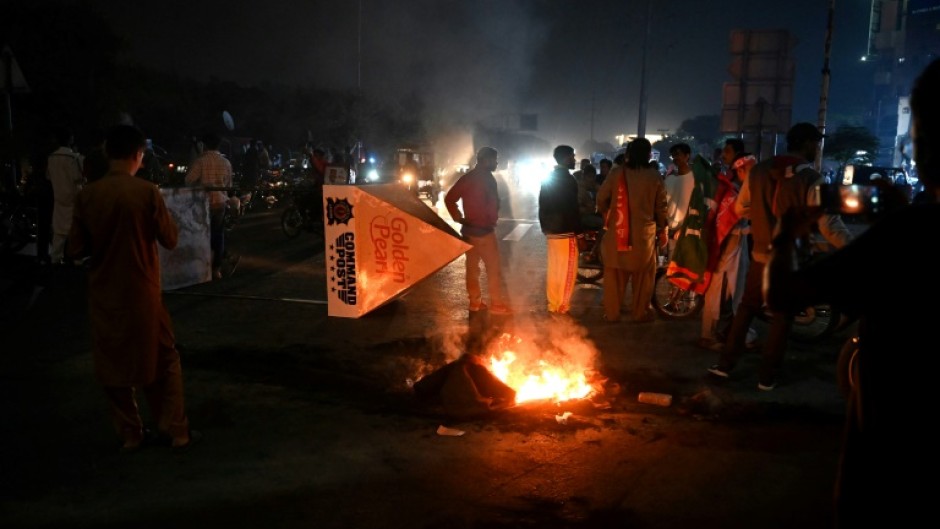 Khan's supporters lit fires and staged protests in Karachi, and other cities, after hearing he had been shot