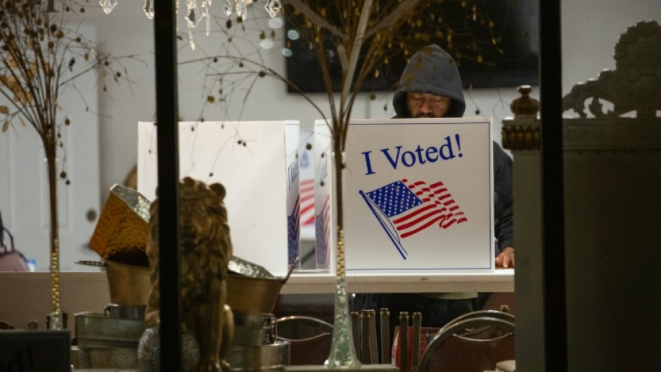 A voter casts his ballot  during the US midterm elections in Pittsburgh, Pennsylvania, on November 8, 2022