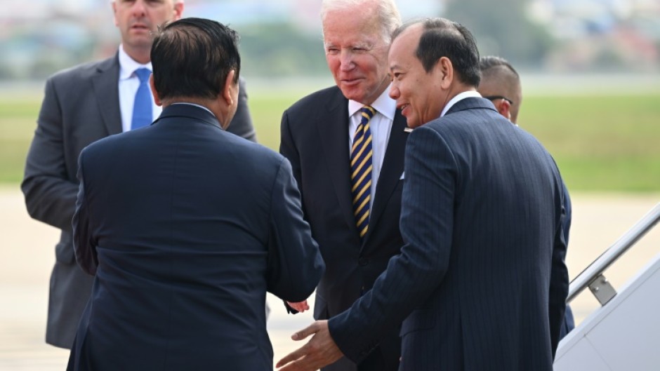 US President Joe Biden (C) is greeted by Cambodian officials after arriving in Phnom Penh on Saturday for an ASEAN summit