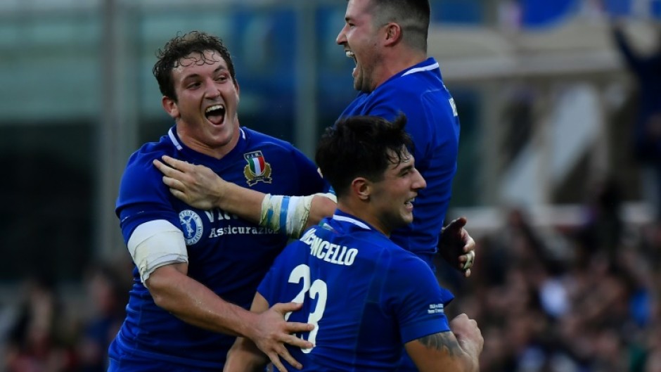 Italy's Michele Lamaro (L), Sebastian Negri (Top R) and Tommaso Menoncello celebrate victory 