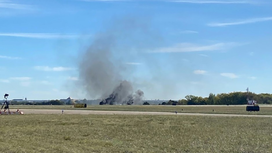 Smoke rises from the crash site after two planes collided mid-air during the Wings Over Dallas Airshow on November 12, 2022