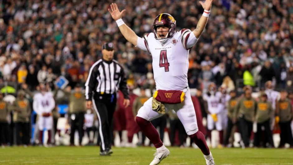 Washington quarterback Taylor Heinicke celebrates a Commanders touchdown as his team upset previously unbeaten Philadelphia 32-21 in Monday's NFL game