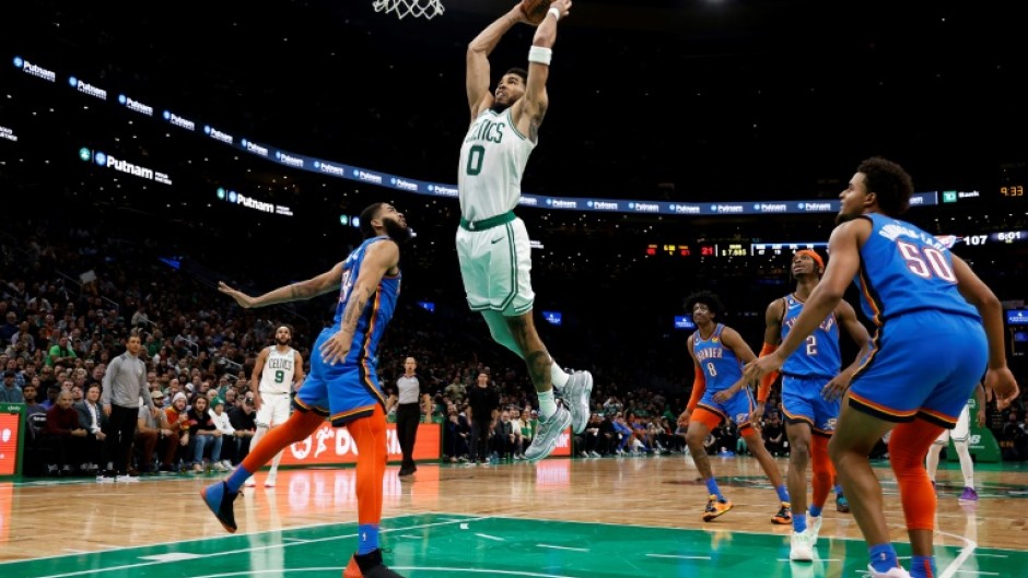 Boston's Jayson Tatum goes in for a slam dunk over Oklahoma City's Kenrich Williams in the Celtics' 126-122 NBA victory