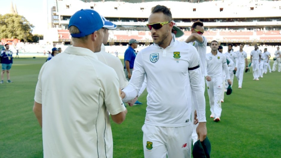 Happier times - Faf du Plessis, then South Africa's captain, (C) shakes hands with Australia' David Warner (L) after the third Test in Adelaide in November 2016. Du Plessis labelled Warner a 'bully' for his role in a dressing room row two years later