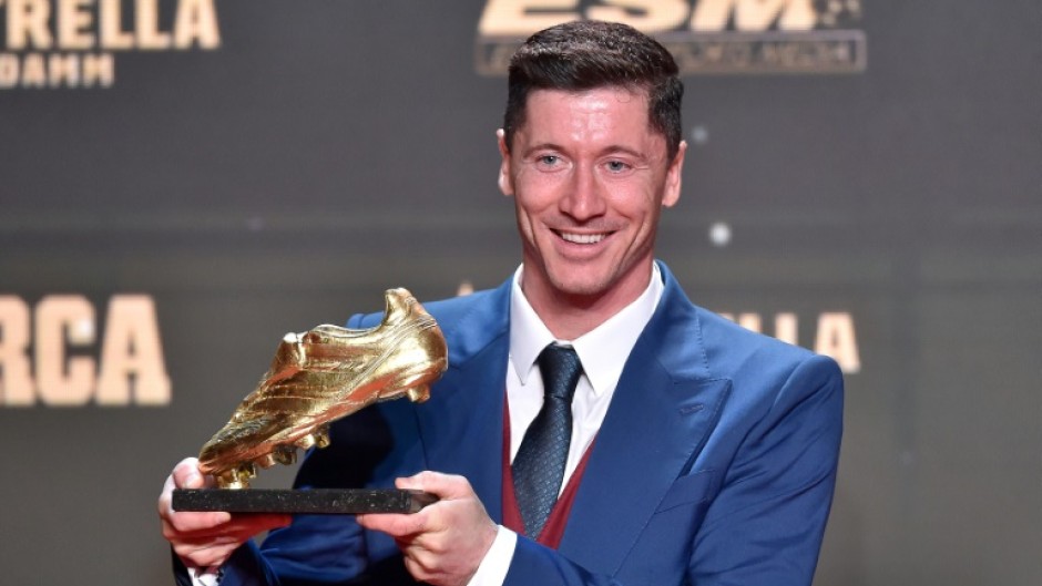 Barcelona's Polish forward Robert Lewandowski poses for pictures holding the Golden Boot trophy during the Golden Boot 2022 award ceremony