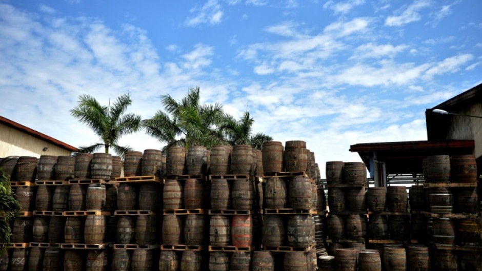 Wooden barrels used to age Havana Club rum are stacked up at the Havana Club's San Jose distillery in Cuba, in 2018