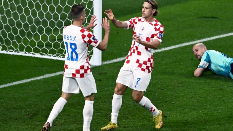 Croatia midfielder Lovro Majer (right) celebrates scoring his team's fourth goal against Canada