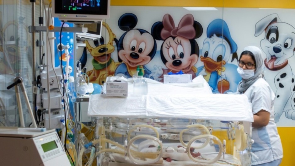 A Moroccan health worker keeps an eye on one of the nine babies after their birth in Casablanca last year