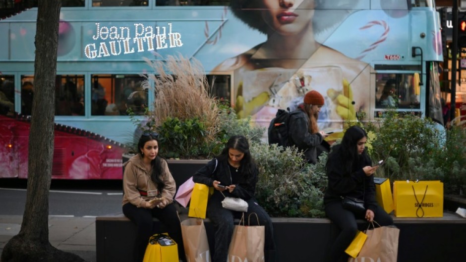 Shoppers with Zara-branded bags in London last month