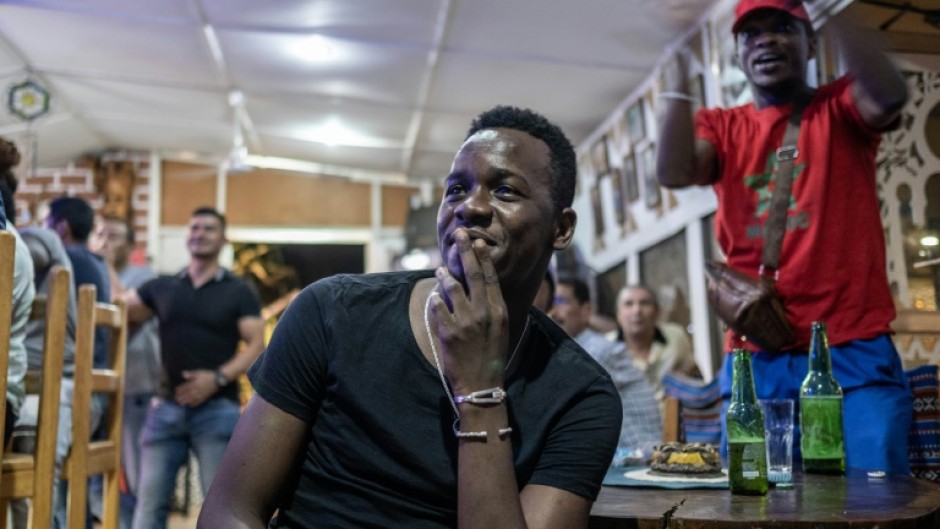 Morocco supporters react while watching a live broadcast of the semi-final match between Morocco and France in Central African Republic