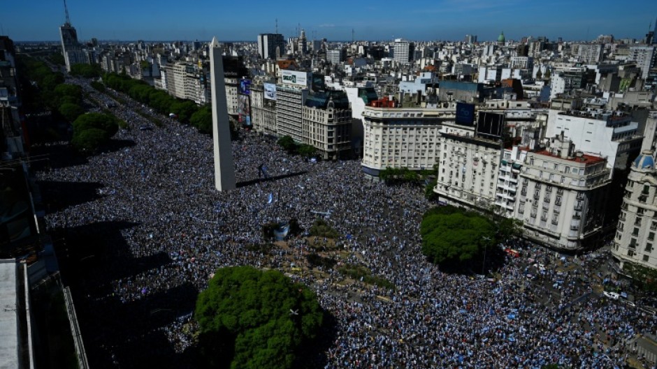 Vast crowds wait for the Argentina players' bus parade in central Buenos Aires to celebrate after winning the Qatar 2022 World Cup