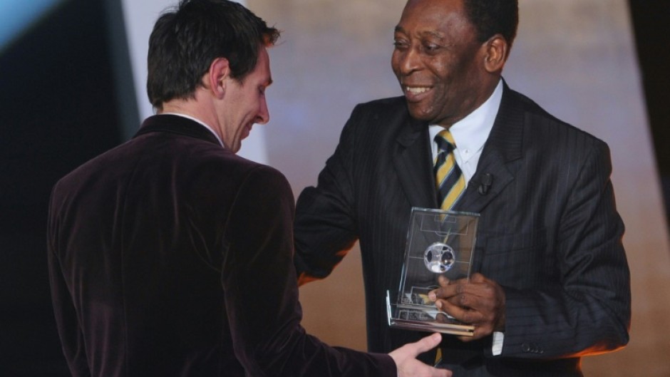 Hand it over: Lionel Messi receives a FIFA World XI award from Pele in 2012