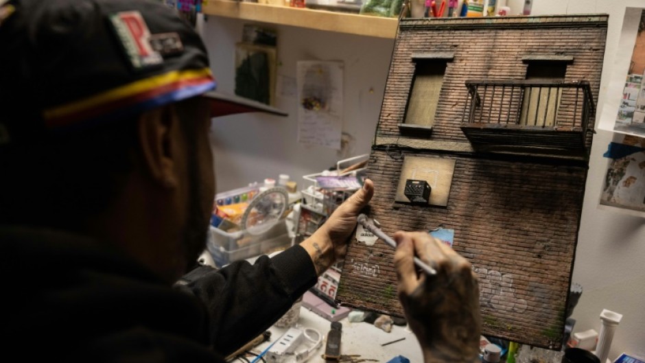 The 42-year-old Danny Cortes adds meticulous detail to one of his miniature New York street scenes