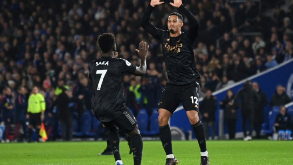 Arsenal's William Saliba (R) and Bukayo Saka celebrate against Brighton 