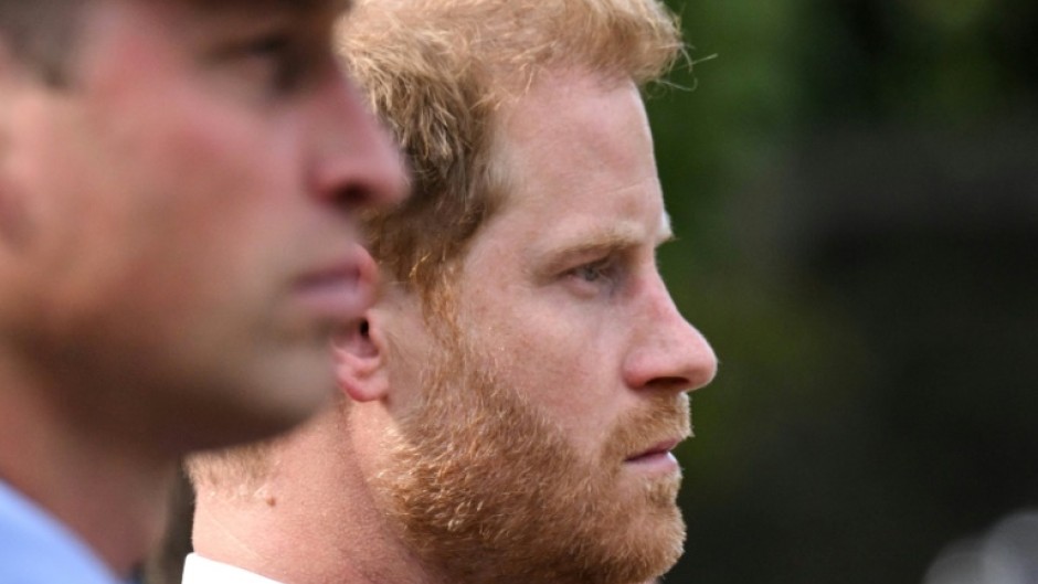 The feud between brothers Britain's Princes William (L) and Harry continues in the run-up to their father King Charles' coronation in May 2023