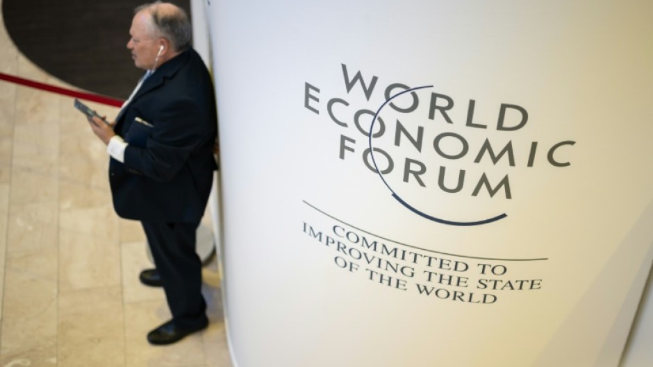 A participant uses his mobile phone at the Congress centre during the World Economic Forum (WEF) annual meeting in Davos on January 18, 2023