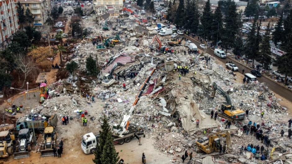 Rescue workers look for survivors in the rebel-held town of Jindayris in Syria