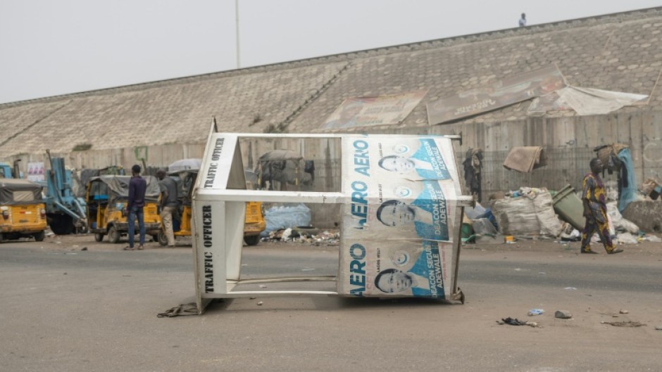 A traffic control booth lies on its side after angry protesters took to the streets of Lagos