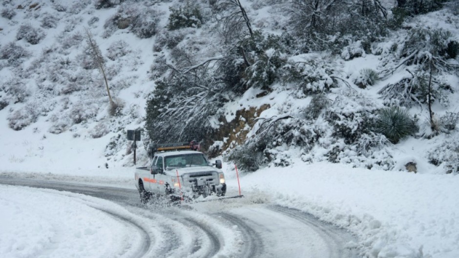 Snow has snarled mountain roads around southern California, as a brutal, and unusual, winter storm grips the area