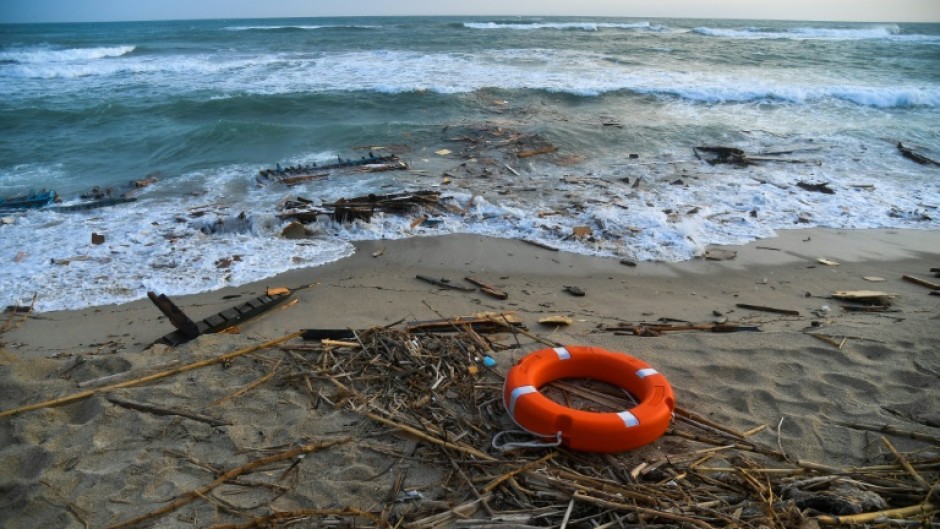 Bodies, shoes and debris have washed up along a stretch of southern Italy shoreline after a migrant boat sank