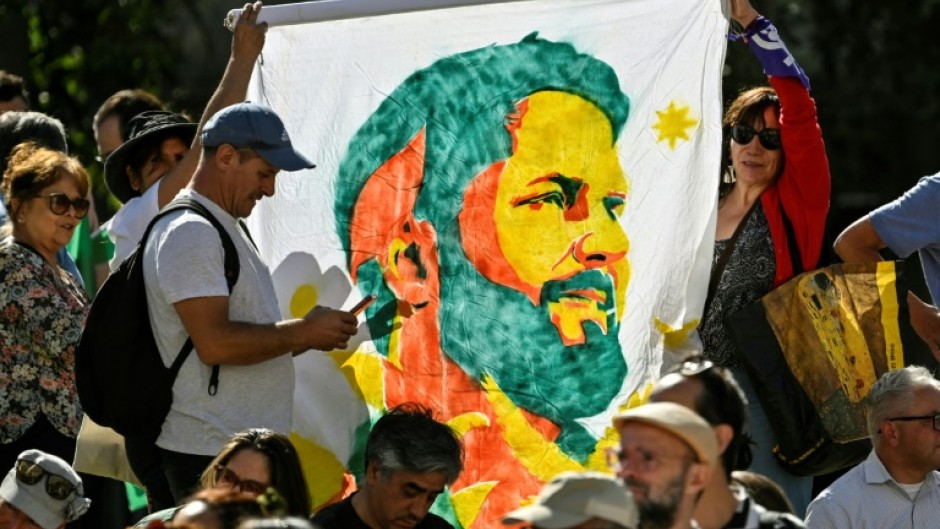 Supporters of Chile's President Gabriel Boric celebrate his first year in office, outside the presidential palace in Santiago, on March 11, 2023