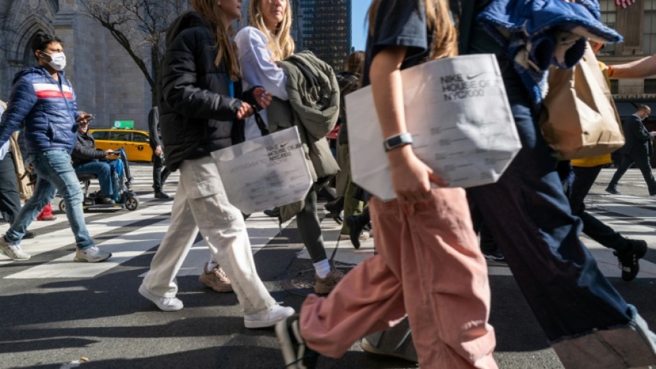 Pedestrians stroll along 5th Avenue in Manhattan, a premier shopping street in New York City  