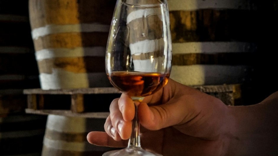 Cuban rum master Cesar Marti tests the density of one of the rums he makes, at the Central Rum Factory in the town of Santo Domingo, Villa Clara Province, some 270 kilometres southeast of Havana, Cuba