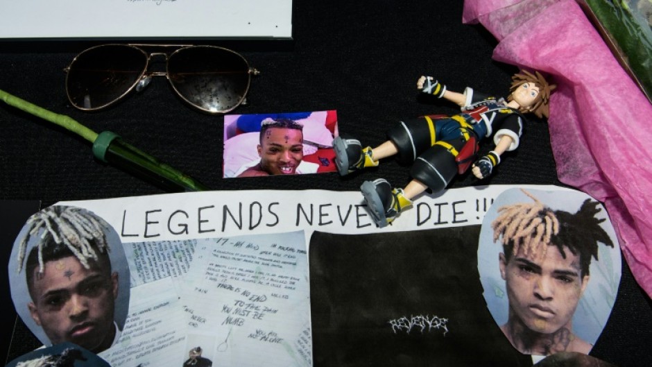 Fans leave items at a makeshift memorial outside XXXTentacion Funeral & Fan Memorial in Florida on June 27, 2018 