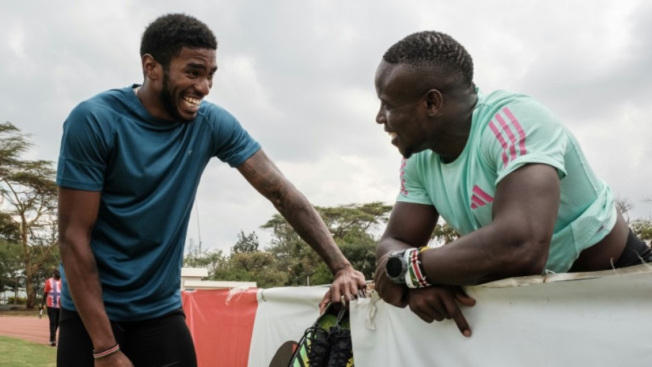 Sharry Dodin (L) soaks up the advice from Commonwealth 100m champion Ferdinand Omanyala after training in Nairobi