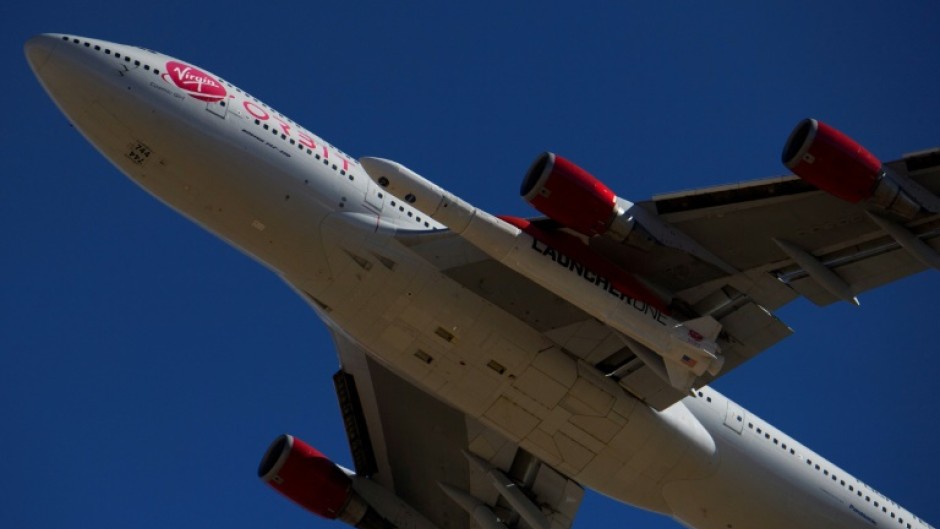 The Virgin Orbit 'Cosmic Girl' -- a modified Boeing 747 carrying a LauncherOne rocket under its wing -- takes off from Mojave Air and Space Port in 2021