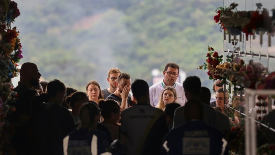 Devastated family members gathered to mourn victims of an attack on a Brazilian preschool, as residents left flowers and teddy bears outside the school