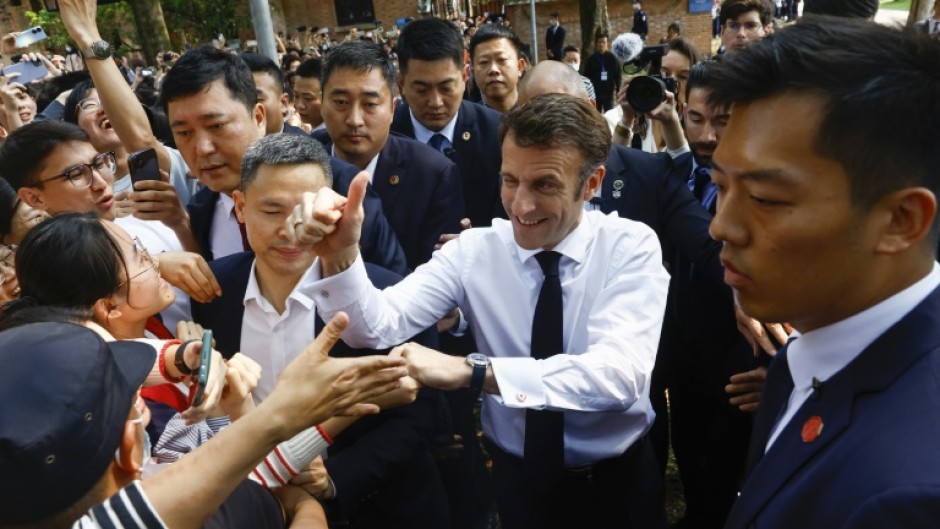 A screaming crowd of students and fans greeted Macron in southern metropolis Guangzhou 